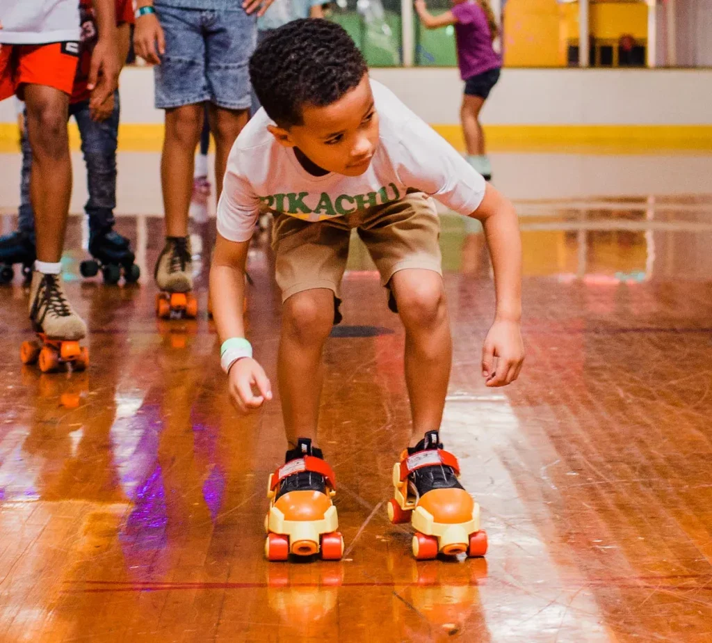 young boy wearing fisher price skates