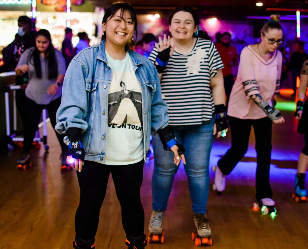 two women skating and smiling